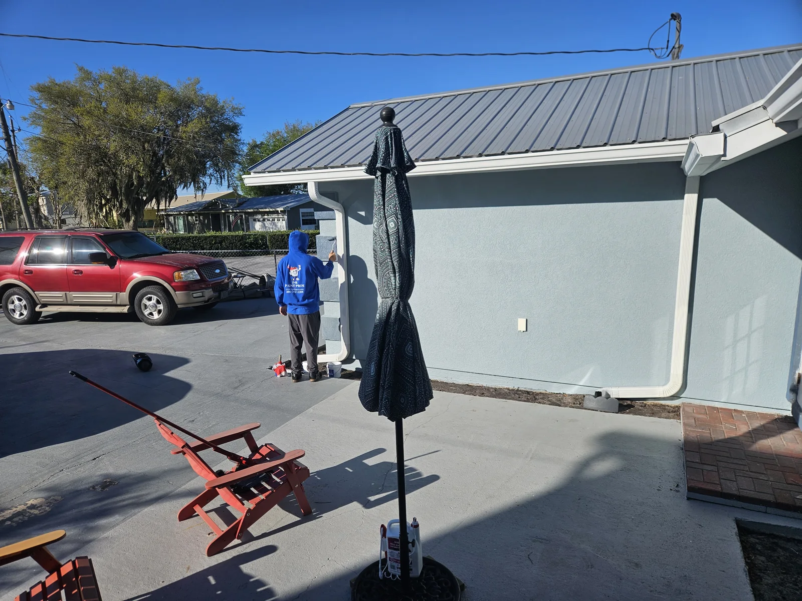 Exterior home painting in Welaka, FL – Freshly painted light blue stucco house with shed, after professional pressure washing, stucco repair, and repaint by T&B Paint Pros LLC, serving Palm Coast, St. Augustine, and Daytona Beach.