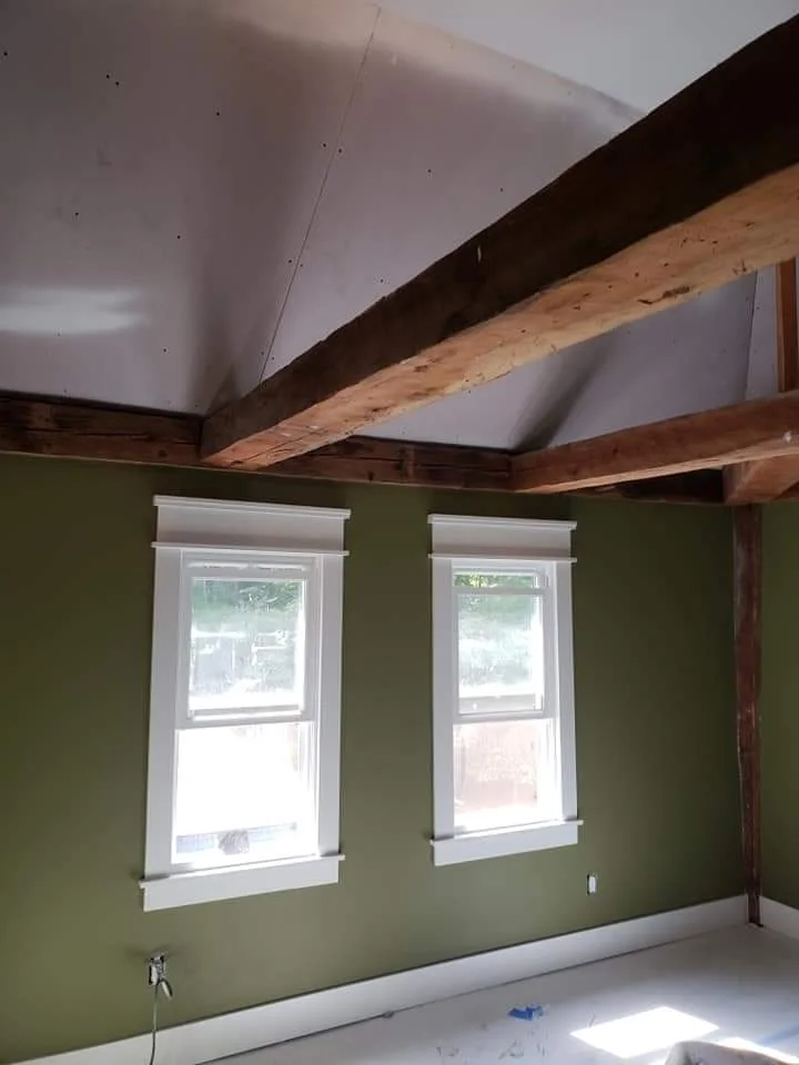 T&B Paint Pros LLC common area transformation with green and white colors. Vaulted ceilings, post-and-beam design, and spacious layout showcase skilled craftsmanship. Flagler County painter, interior home painting, home improvement.