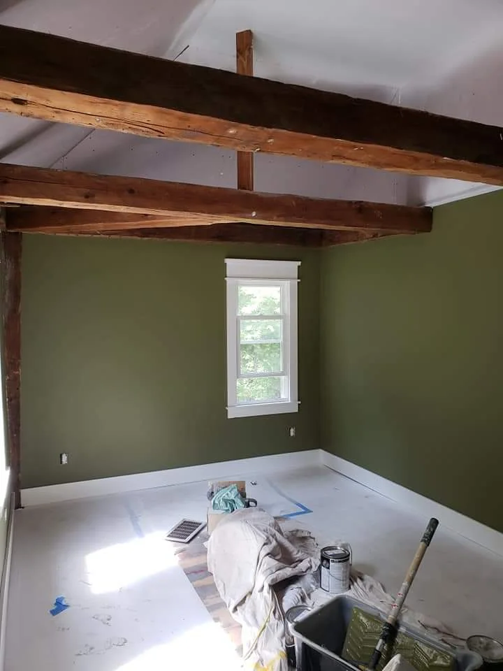 T&B Paint Pros LLC common area repaint with green and white color scheme. Vaulted ceilings and post-and-beam features create a stunning focal point. Flagler County painter, home renovation, interior painting, professional craftsmanship