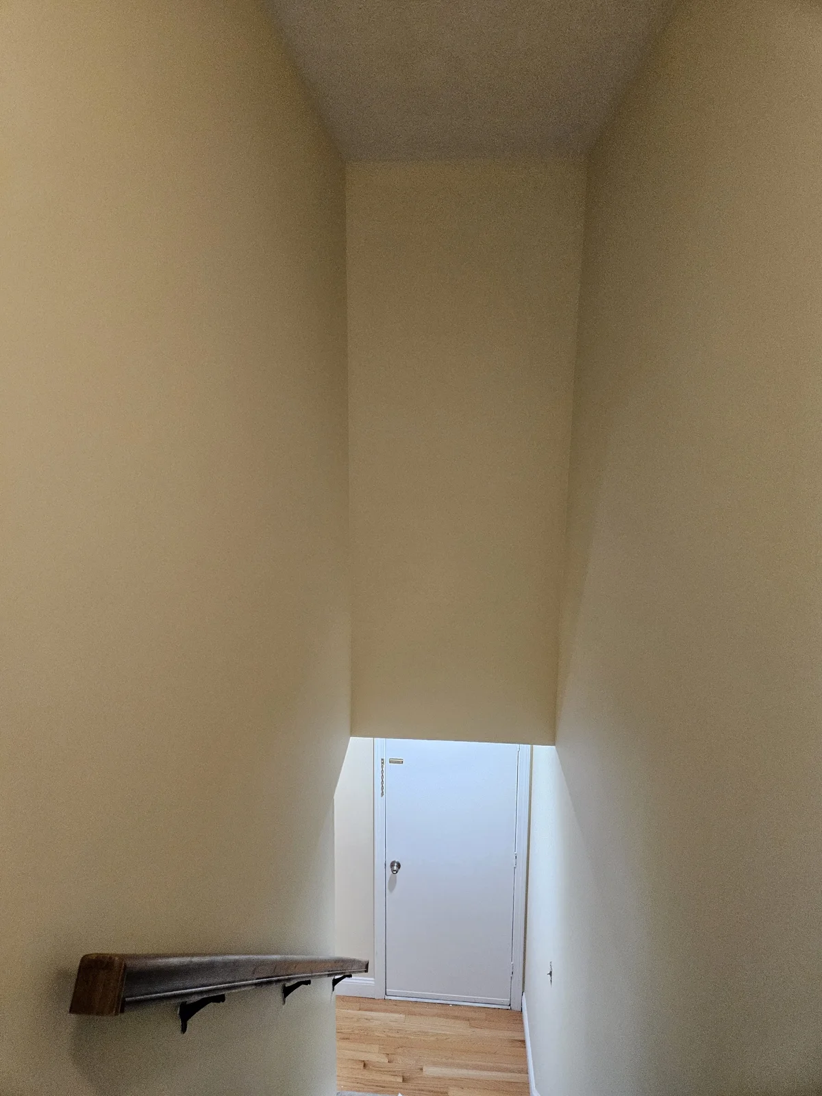Freshly painted stairwell with off-white walls, showcasing the bright transformation by T&B Paint Pros. Flagler County Painter, Stairs Repaint, T&B Paint Pros LLC.