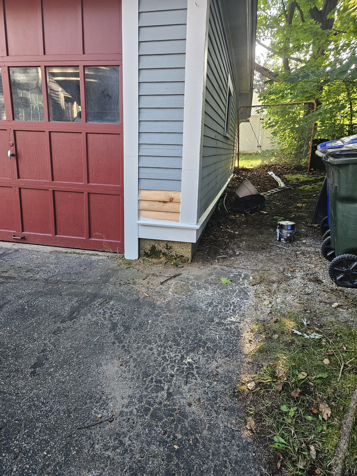 Garage siding repair in progress—fresh wood replacement before expert exterior painting. T&B Paint Pros provides top-quality siding repair and repainting. tbpaintpros Flagler County Florida experienced painter, specializing in garage exterior restoration.